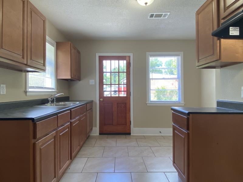 4711 Dalton Road Memphis, TN 38109 - Photo 4 of 8 a kitchen with a stove and a refrigerator