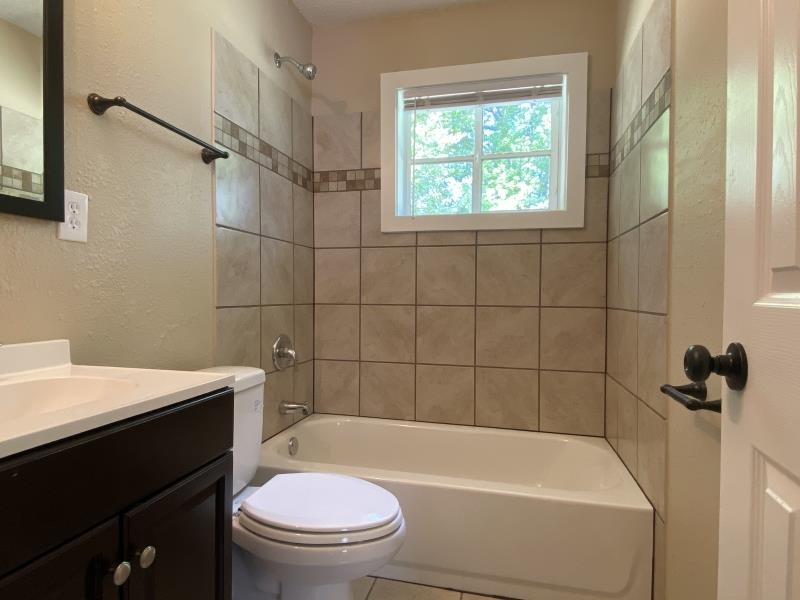 4711 Dalton Road Memphis, TN 38109 - Photo 6 of 8 a bathroom with a sink a toilet and a bathtub