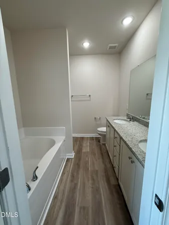 a bathroom with a sink a mirror and a bathtub
