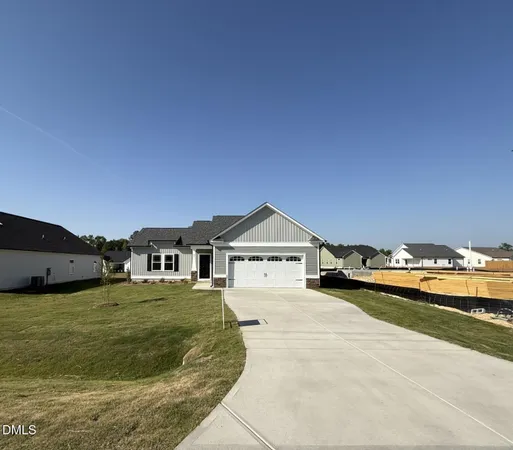 a view of a house with yard and sitting area