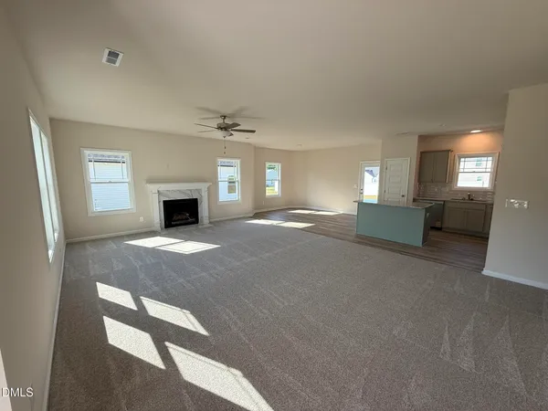a view of empty room with a fireplace