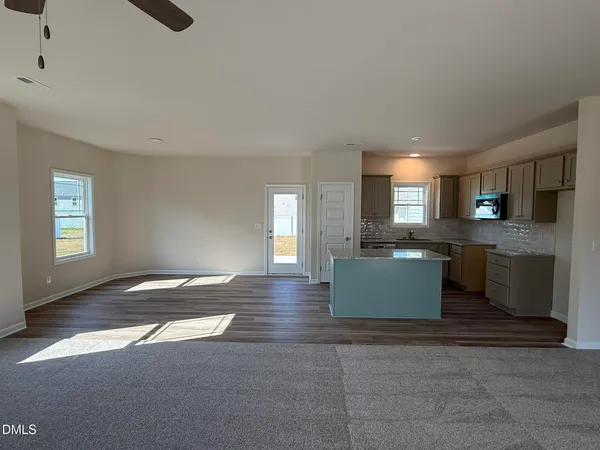 a view of kitchen and hall with wooden floor