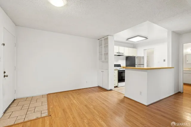 a view of a kitchen with wooden floor and windows