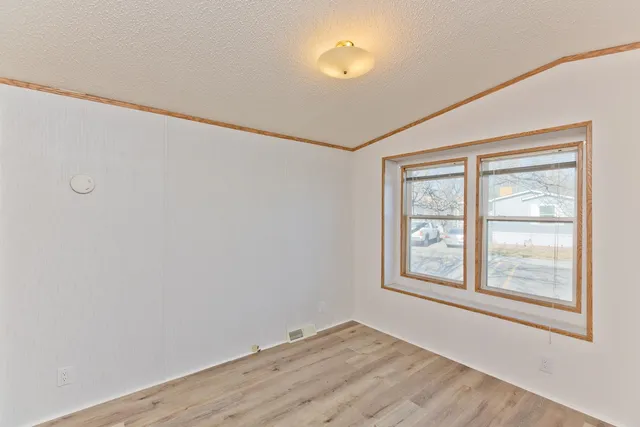 an empty room with windows and closet