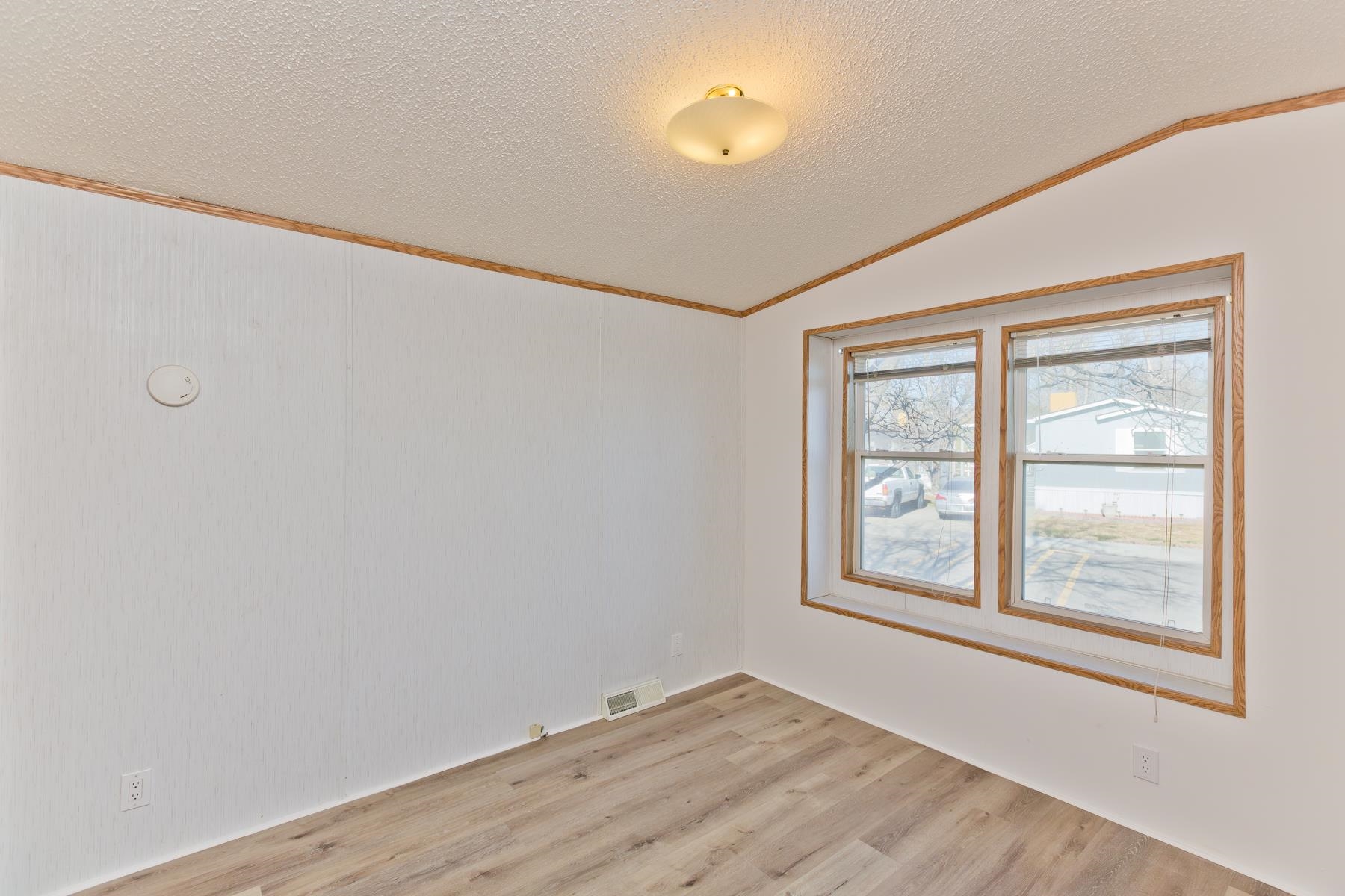 435 32 Road, Unit 521 Clifton, CO 81520 - Photo 13 of 26 an empty room with wooden floor and windows