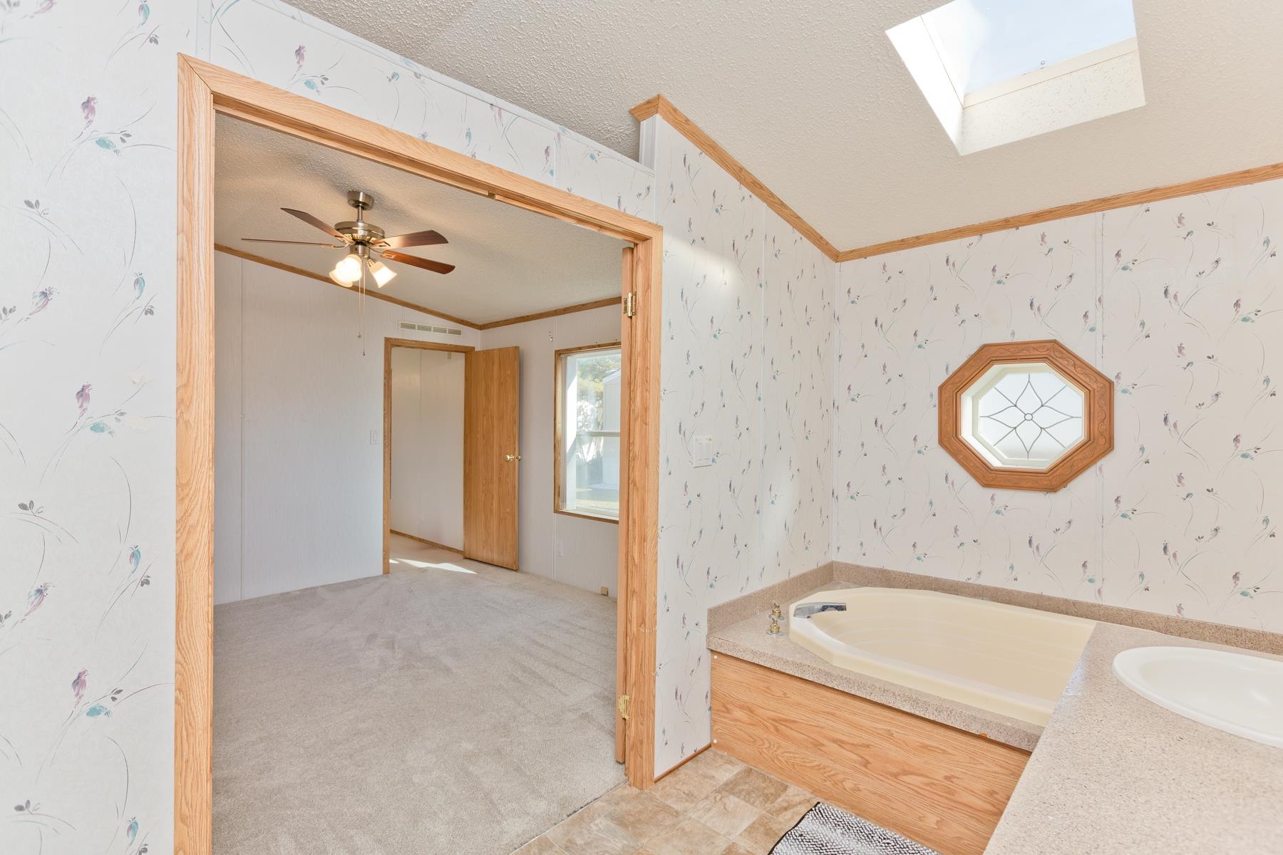 435 32 Road, Unit 521 Clifton, CO 81520 - Photo 16 of 26 a bathroom with a tub a sink and a shower curtain