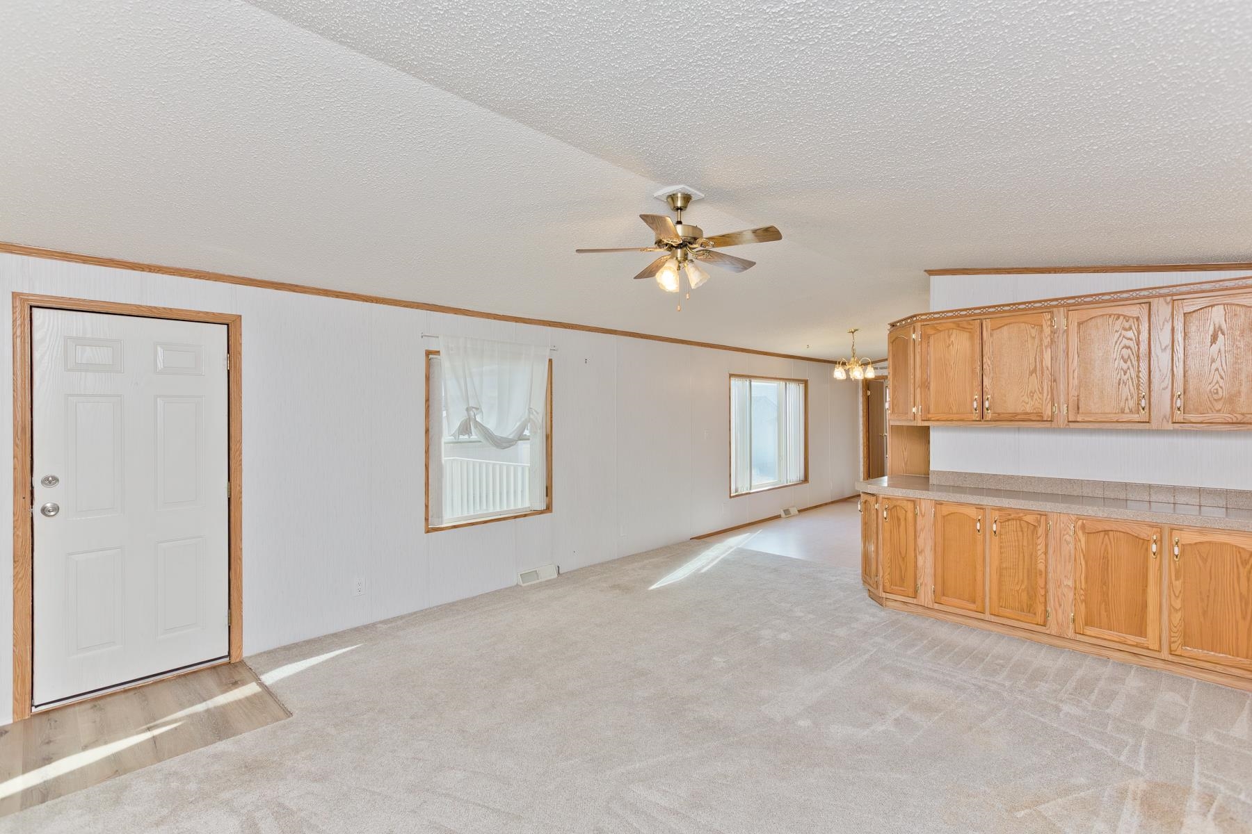 435 32 Road, Unit 521 Clifton, CO 81520 - Photo 17 of 26 an empty room with chandelier fan and windows