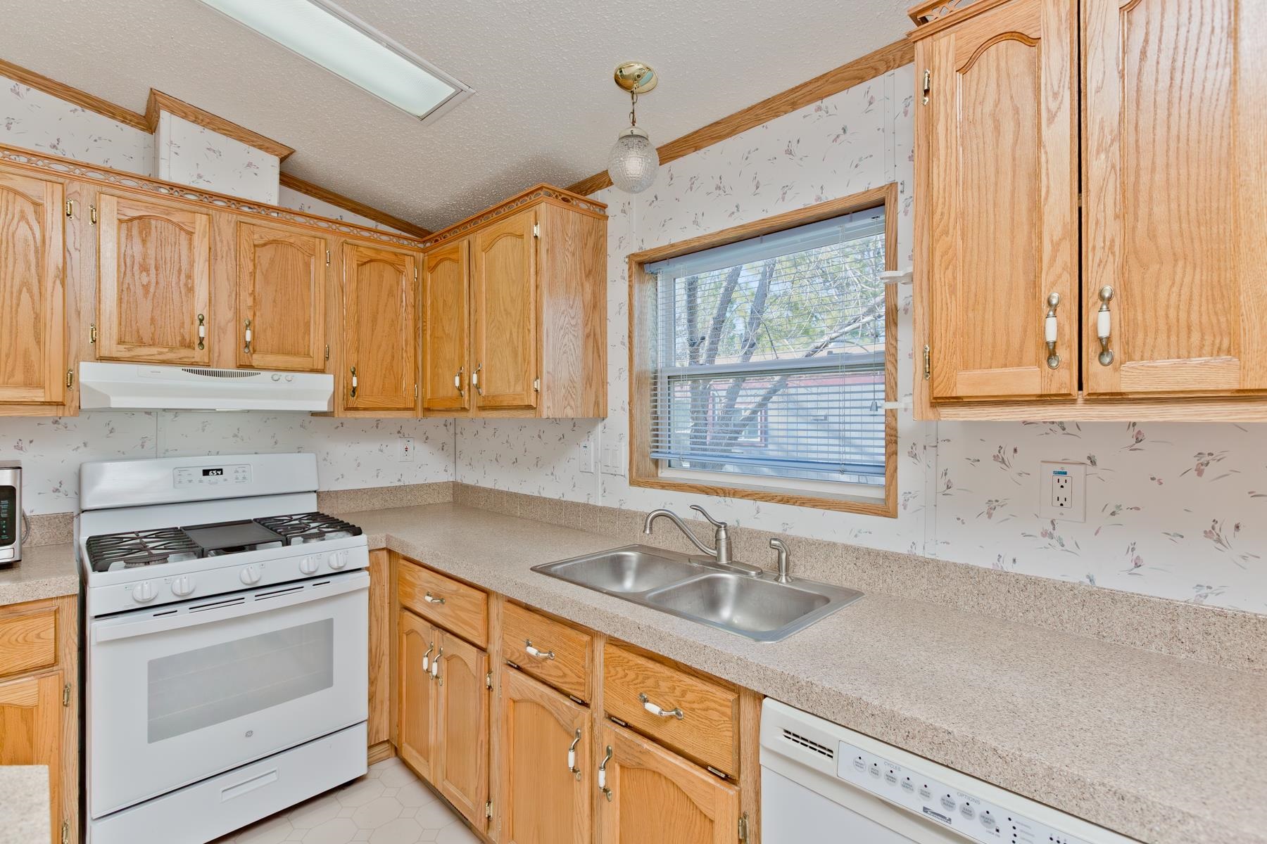 435 32 Road, Unit 521 Clifton, CO 81520 - Photo 23 of 26 a kitchen with granite countertop a sink cabinets stainless steel appliances and a window