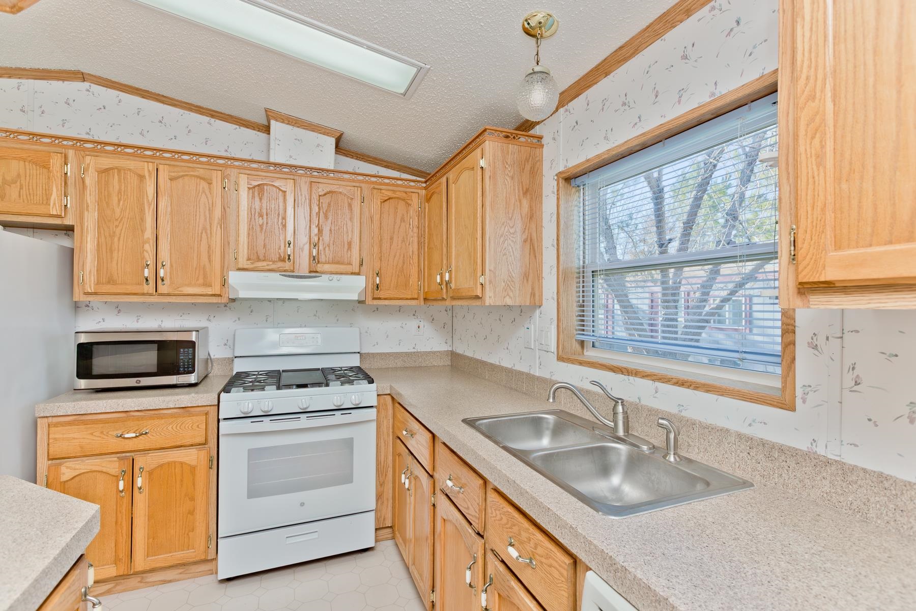435 32 Road, Unit 521 Clifton, CO 81520 - Photo 24 of 26 a kitchen with granite countertop a sink stove top oven and cabinets