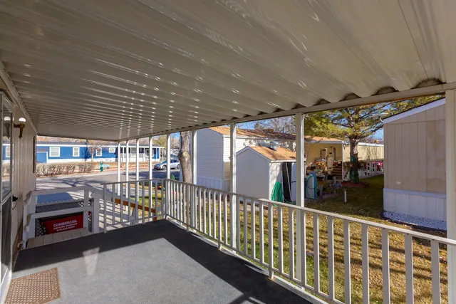 a view of a house with wooden deck