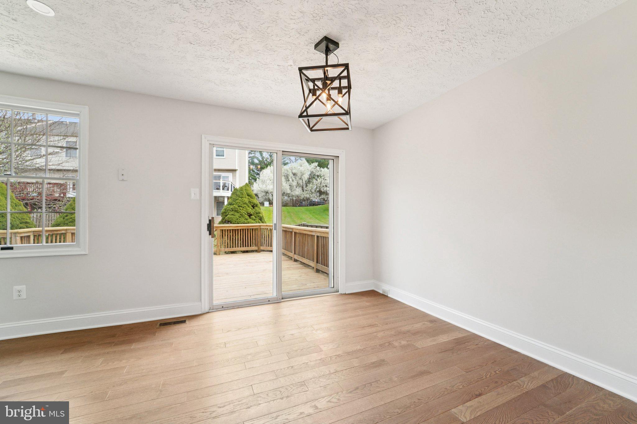 8727 Silver Hall Road Perry Hall, MD 21128 - Photo 6 of 35 an empty room with wooden floor cabinet and window