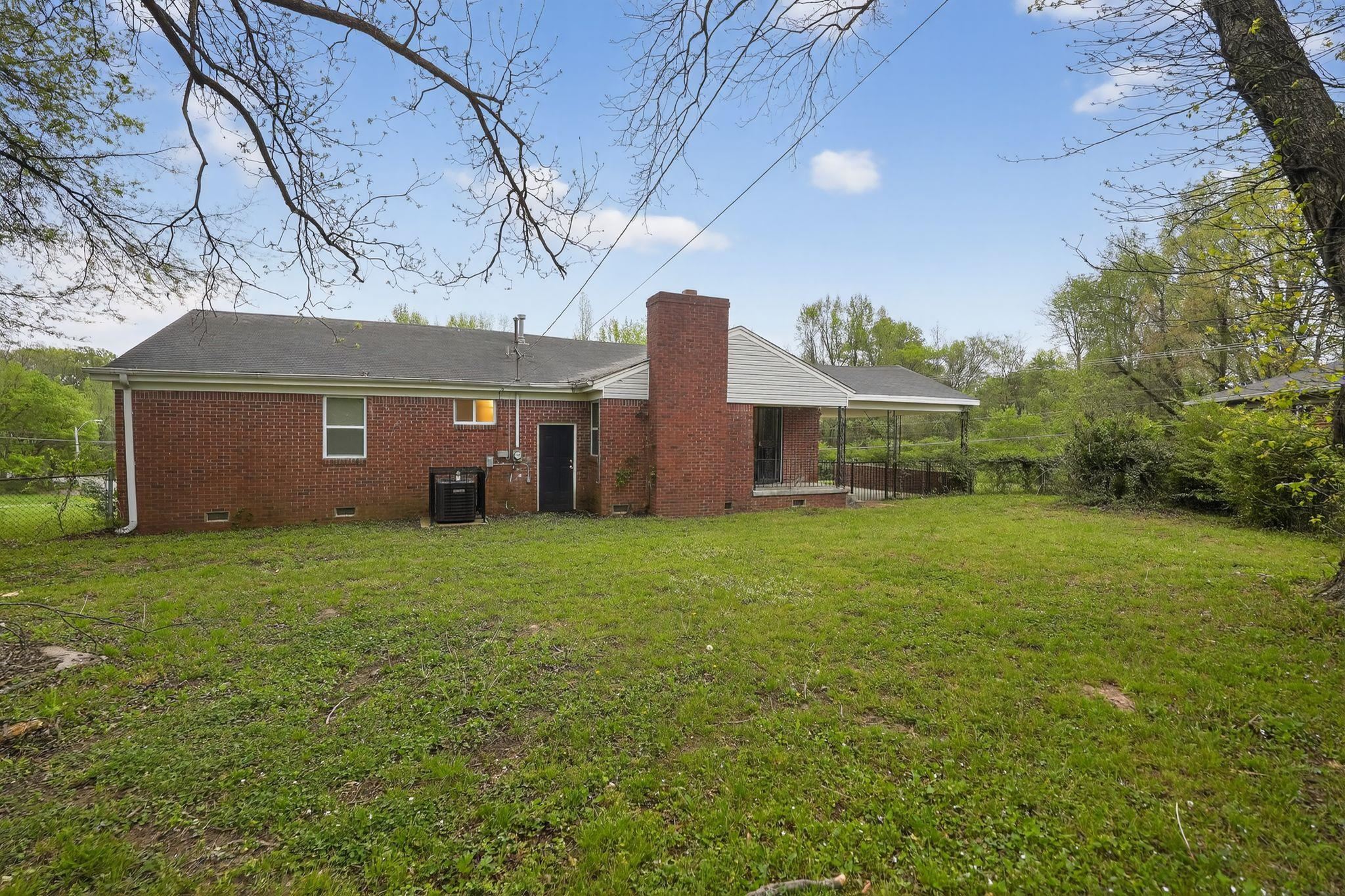 134 West Holmes Road Memphis, TN 38109 - Photo 11 of 30 Rear view of house with crawl space, a chimney, and brick siding