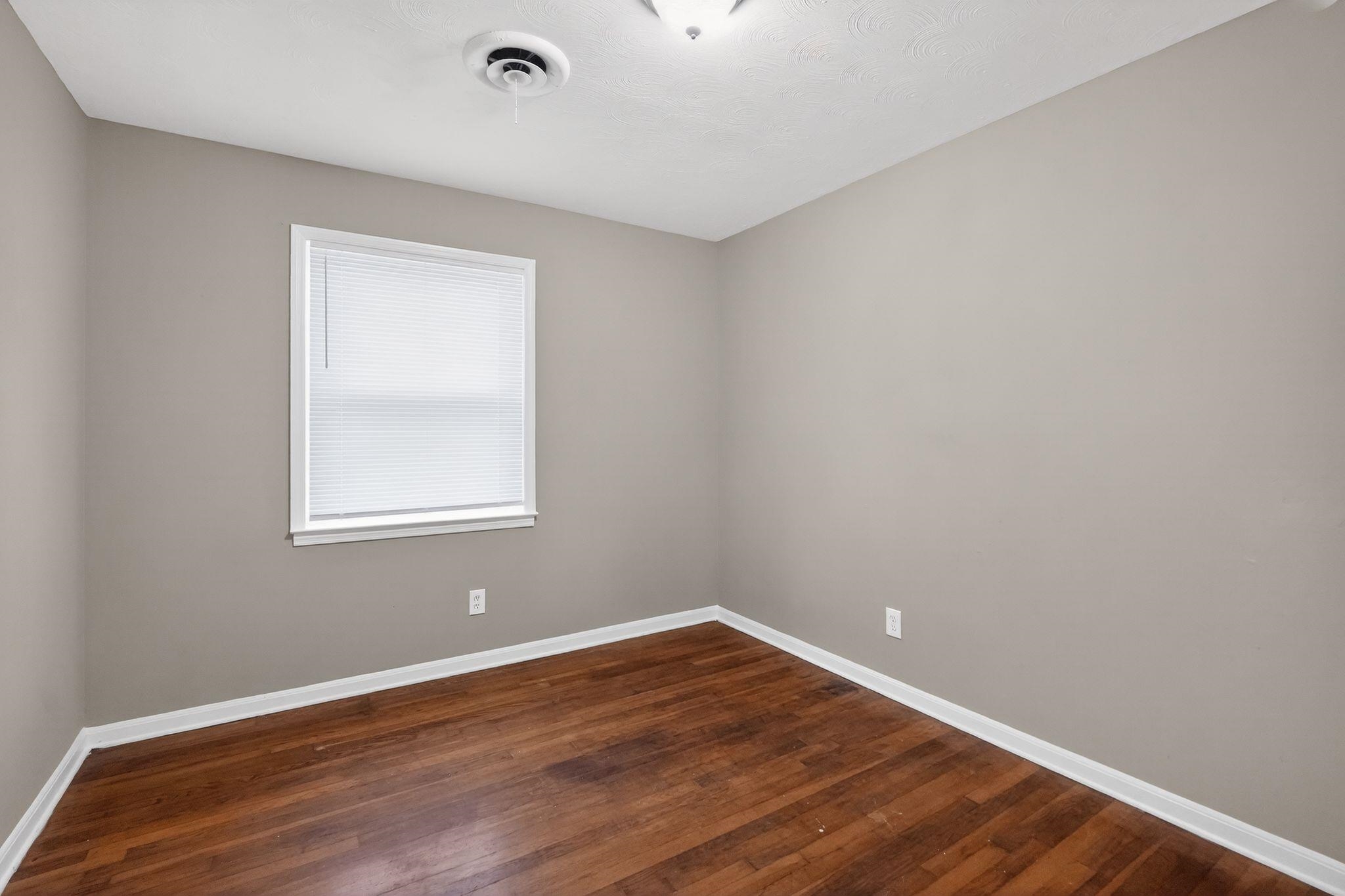 134 West Holmes Road Memphis, TN 38109 - Photo 13 of 30 Unfurnished room featuring baseboards and dark wood-style floors