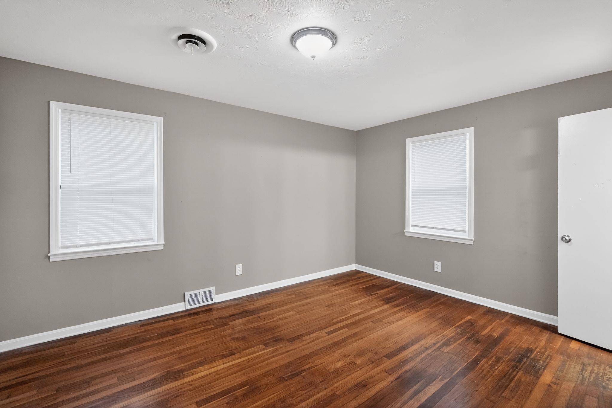 134 West Holmes Road Memphis, TN 38109 - Photo 14 of 30 Empty room featuring dark wood finished floors and baseboards