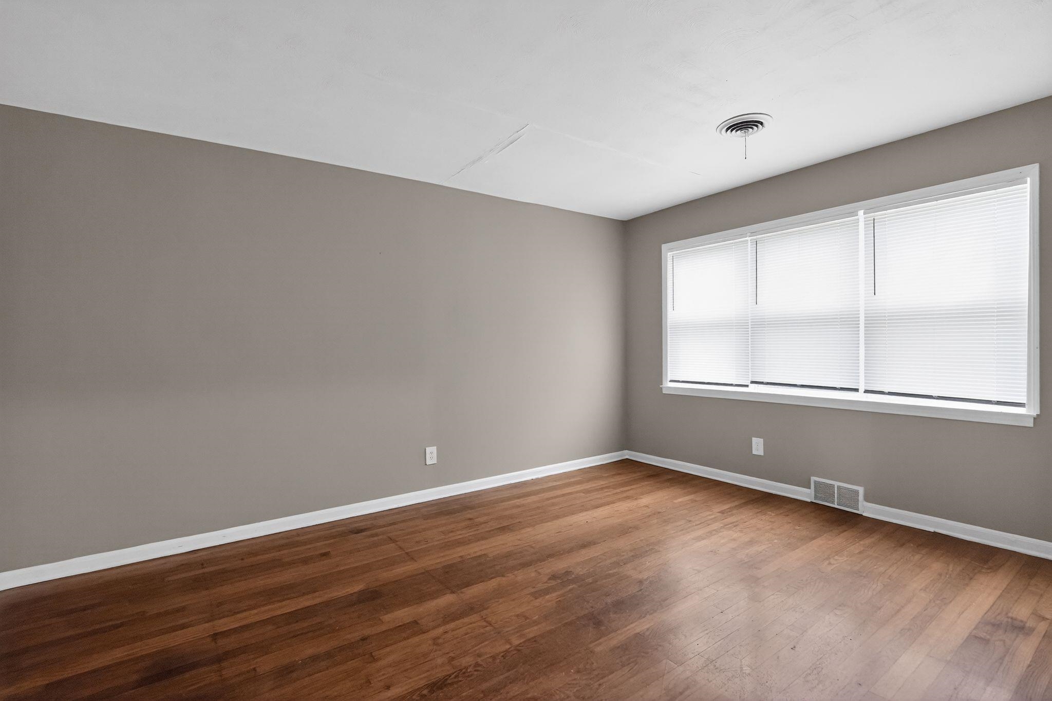 134 West Holmes Road Memphis, TN 38109 - Photo 18 of 30 Empty room featuring dark wood-style flooring and baseboards