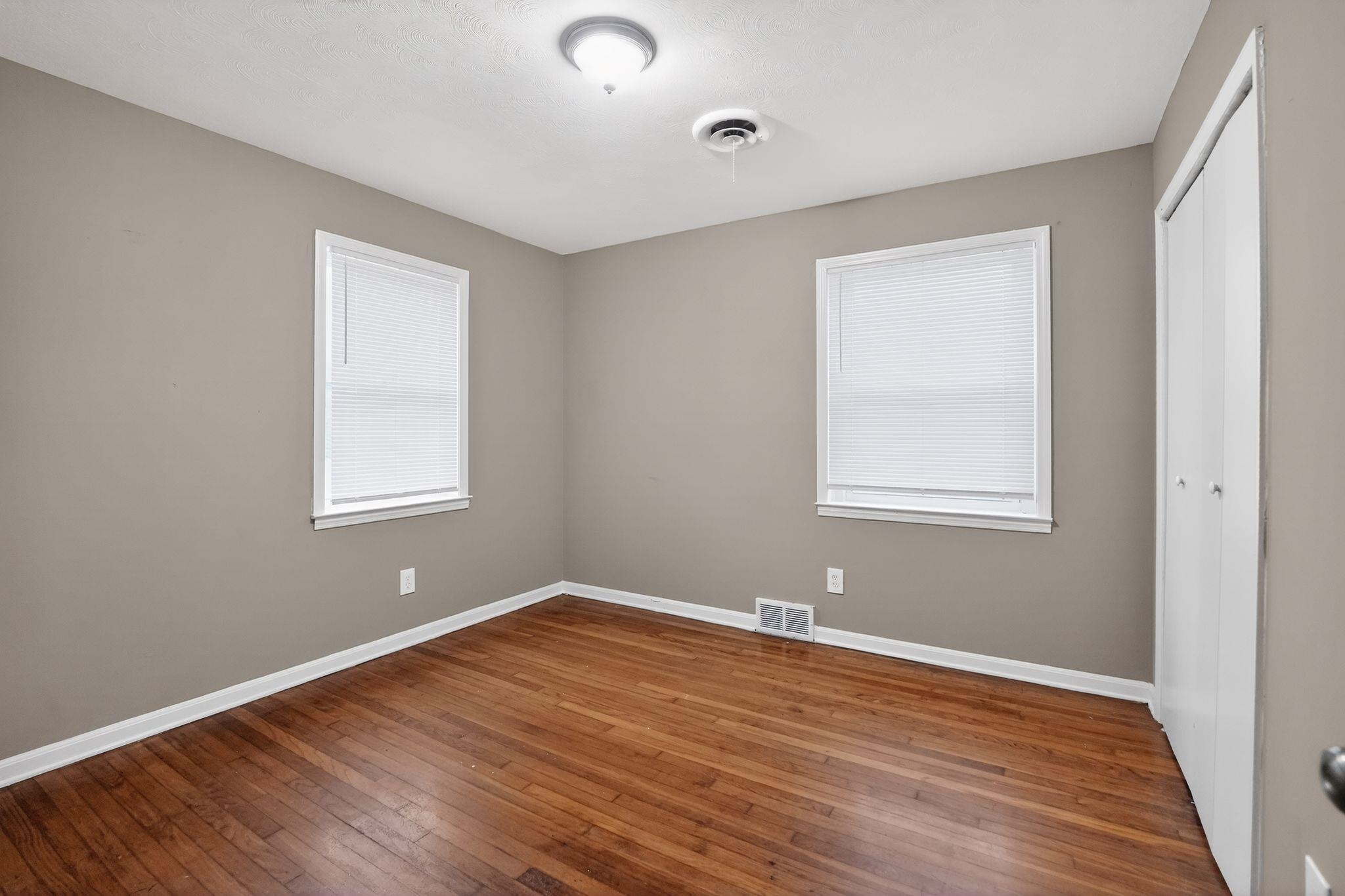 134 West Holmes Road Memphis, TN 38109 - Photo 21 of 30 Unfurnished bedroom with dark wood finished floors and a closet