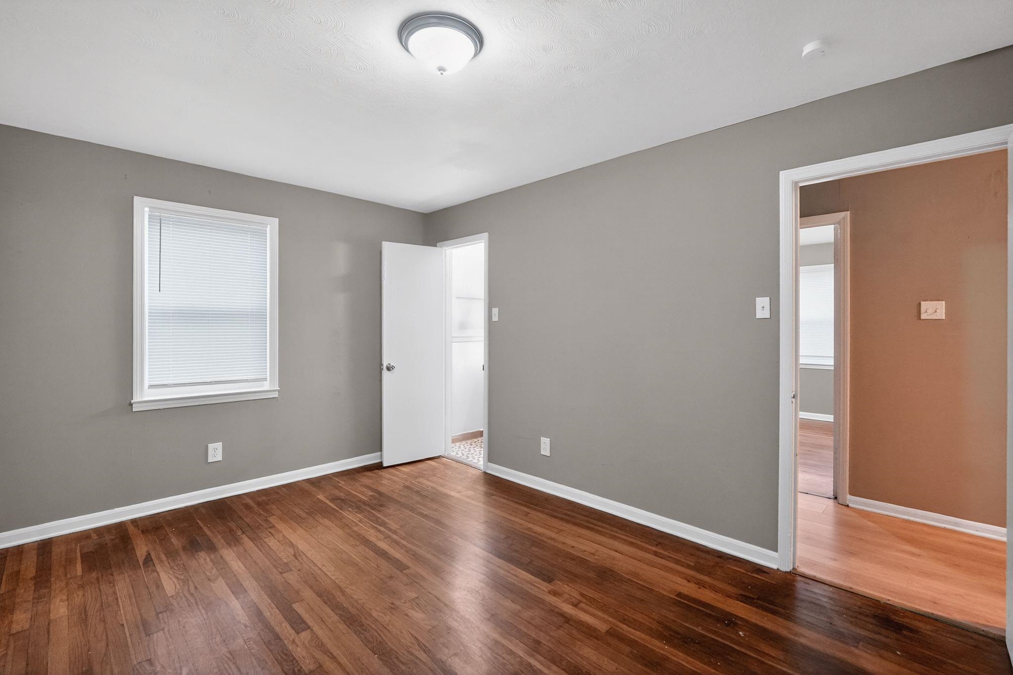 134 West Holmes Road Memphis, TN 38109 - Photo 23 of 30 Empty room with dark wood finished floors