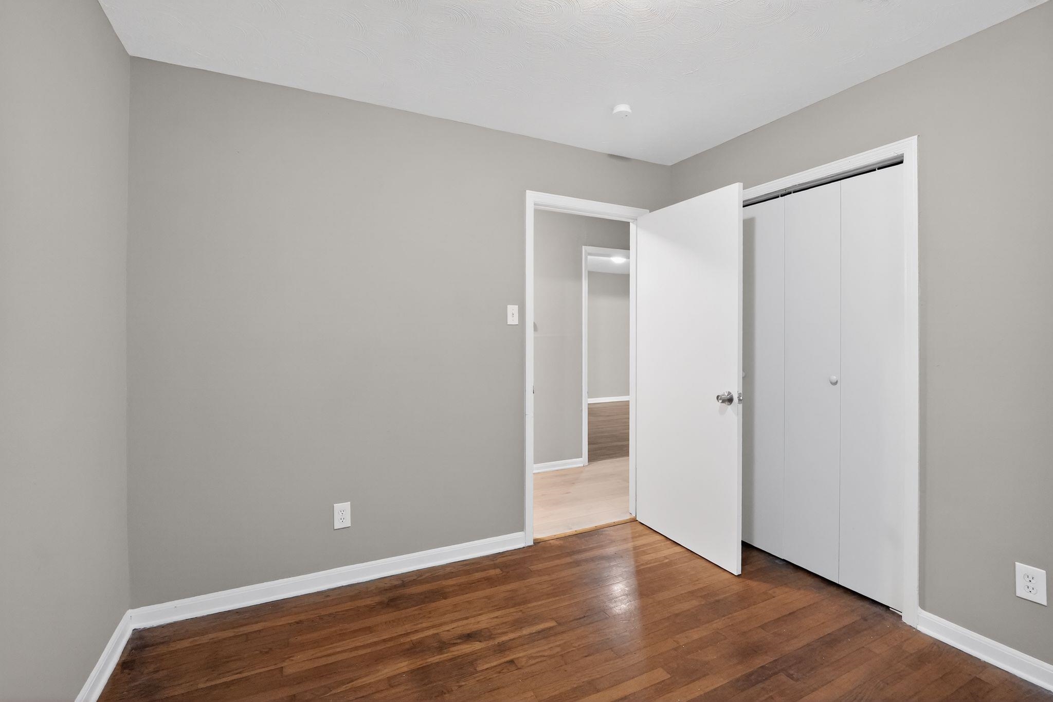 134 West Holmes Road Memphis, TN 38109 - Photo 24 of 30 Unfurnished bedroom with dark wood finished floors and a closet