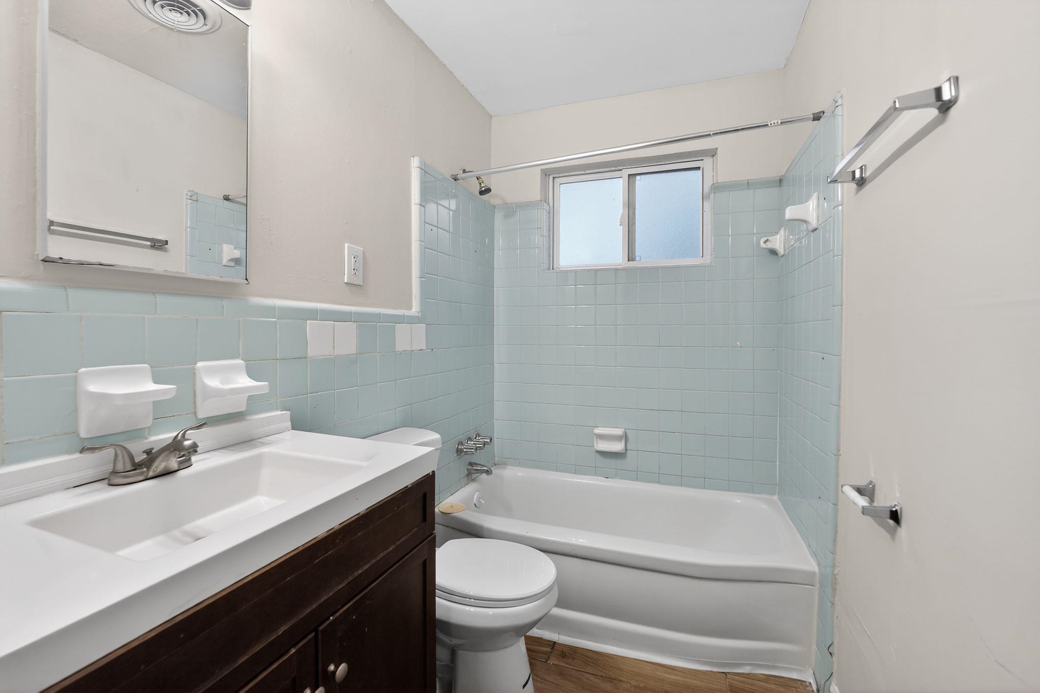 134 West Holmes Road Memphis, TN 38109 - Photo 26 of 30 Full bath with vanity, shower / tub combination, tile walls, and a wainscoted wall