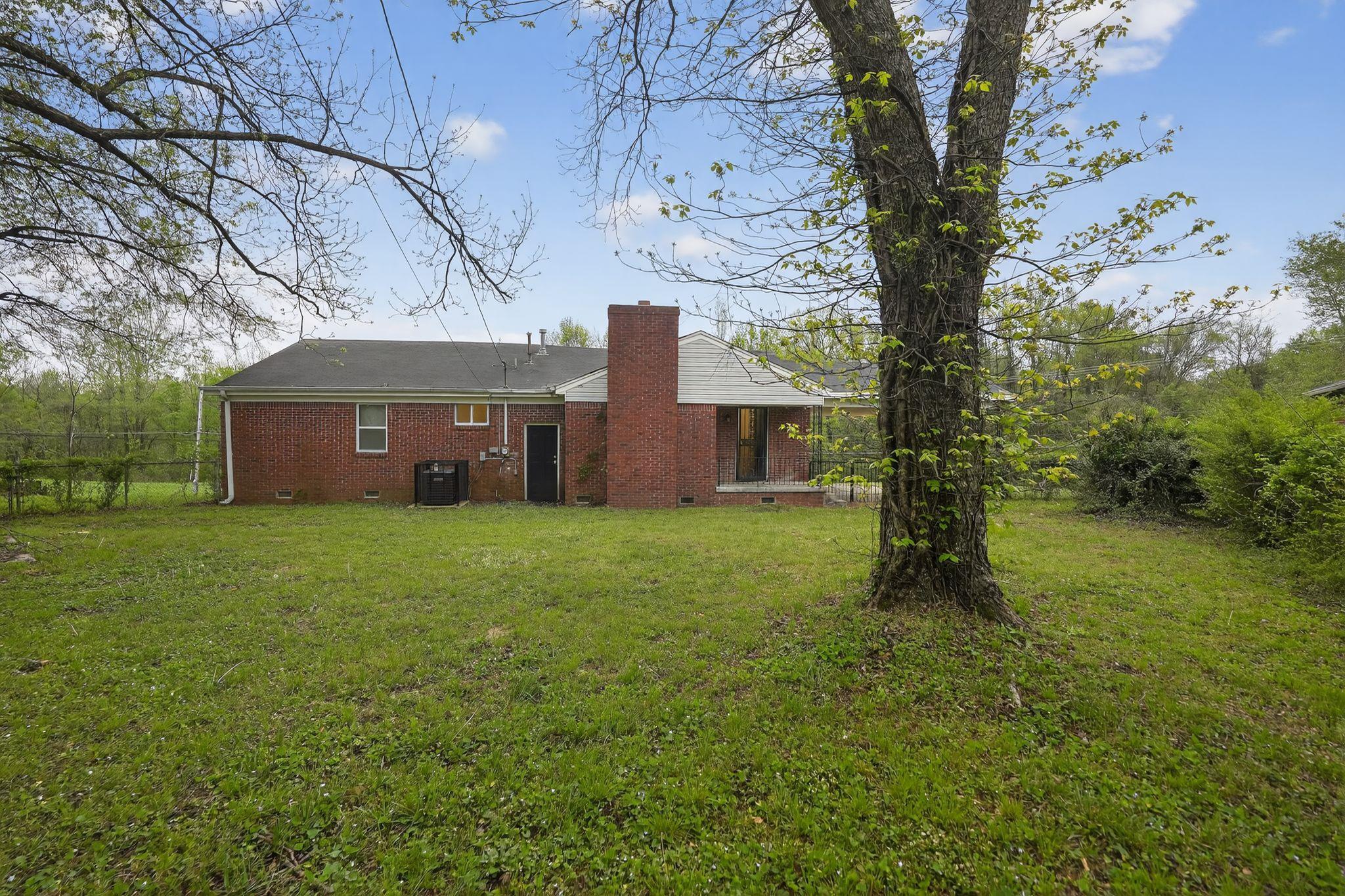 134 West Holmes Road Memphis, TN 38109 - Photo 9 of 30 Rear view of property with crawl space, a chimney, and a yard