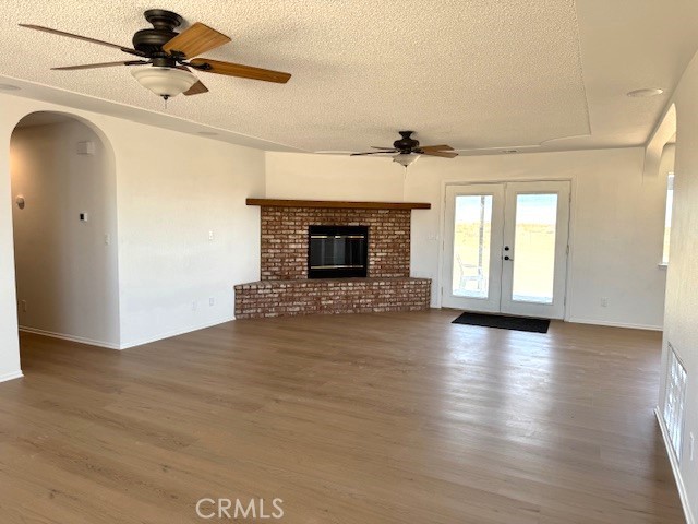 36749 Esaw Road Lucerne Valley, CA 92356 - Photo 4 of 22 a view of a room with wooden floor and fireplace