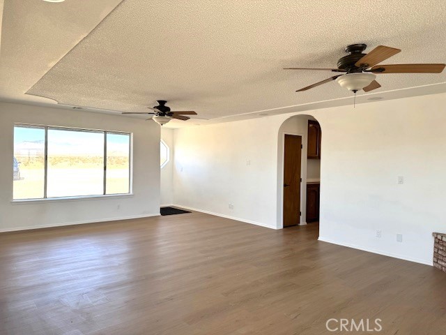 36749 Esaw Road Lucerne Valley, CA 92356 - Photo 5 of 22 wooden floor in an empty room with a window