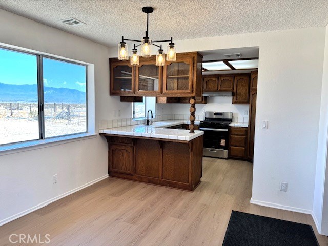 36749 Esaw Road Lucerne Valley, CA 92356 - Photo 6 of 22 a kitchen with stainless steel appliances granite countertop a stove and a wooden floors