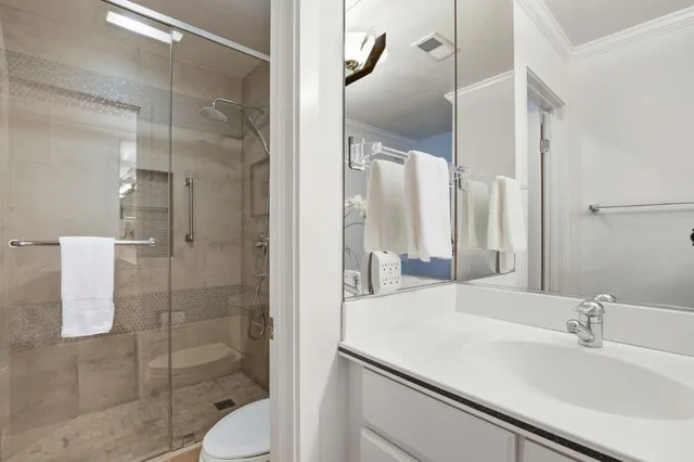 a bathroom with a sink toilet and shower