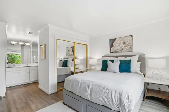 a bedroom with a large bed and a chandelier