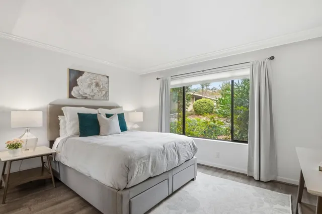 a bedroom with a large bed and a window