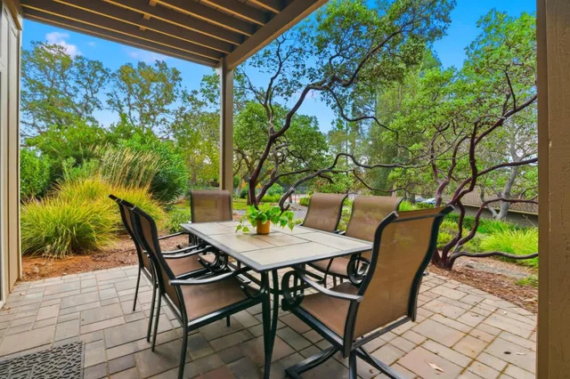 a view of a patio with table and chairs and potted plants