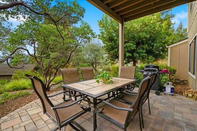 a view of a patio with table and chairs and potted plants