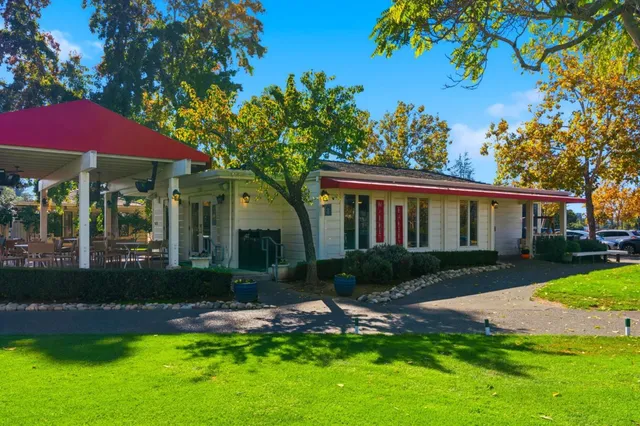 a front view of a house with a yard table and chairs
