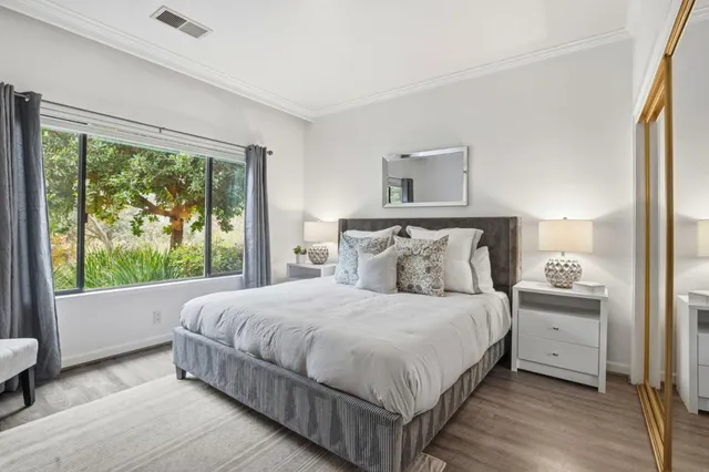 a bedroom with a large bed and a large window