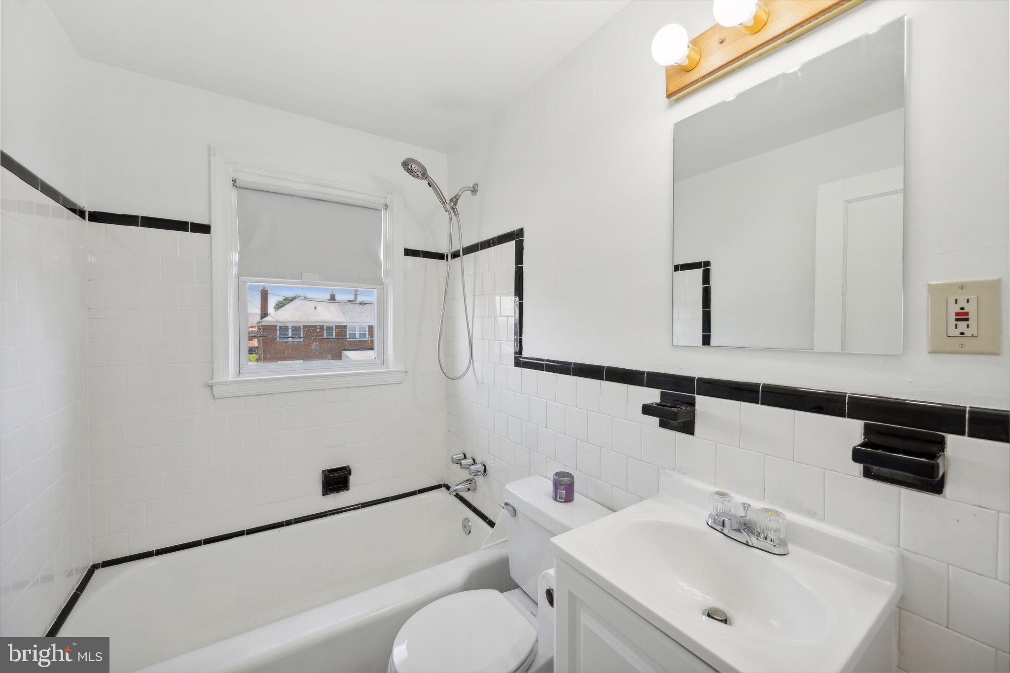 2116 Firethorn Road Middle River, MD 21220 - Photo 18 of 26 a bathroom with a sink mirror and a bathtub
