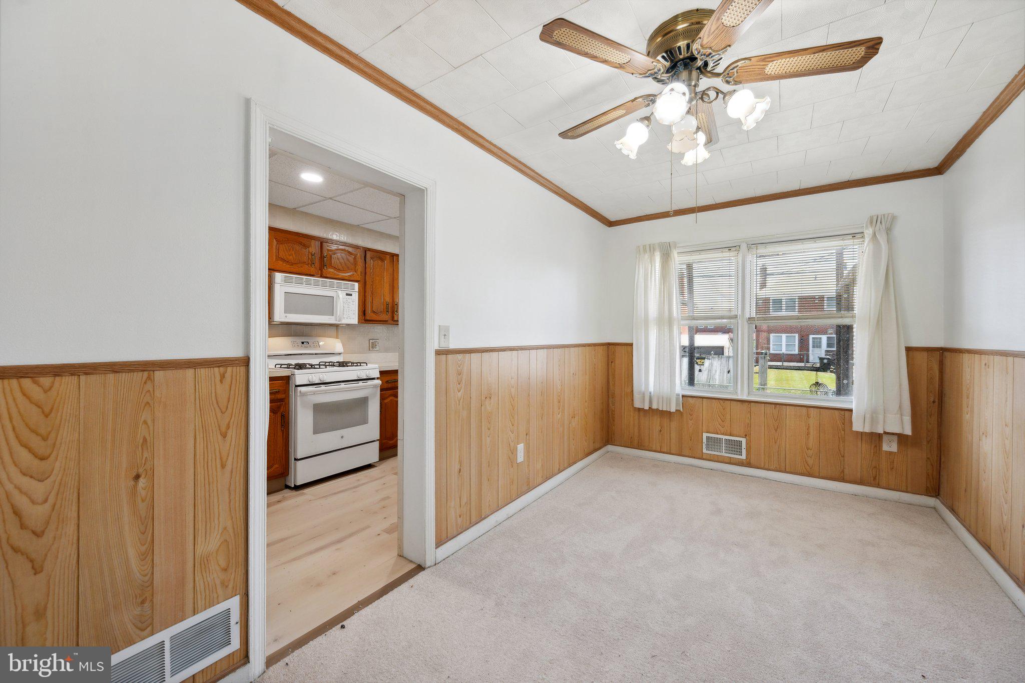 2116 Firethorn Road Middle River, MD 21220 - Photo 7 of 26 a view of a kitchen with fridge and a ceiling fan