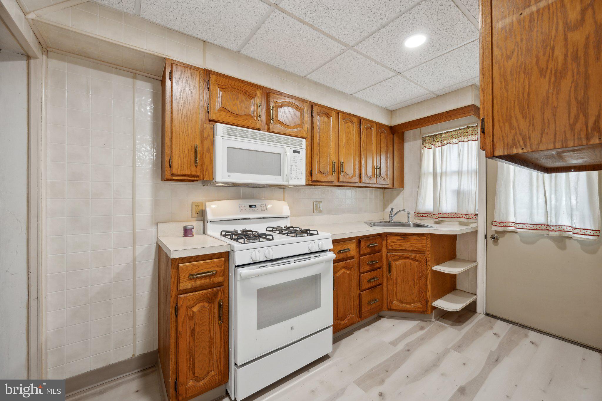 2116 Firethorn Road Middle River, MD 21220 - Photo 8 of 26 a kitchen with a stove a sink and a refrigerator