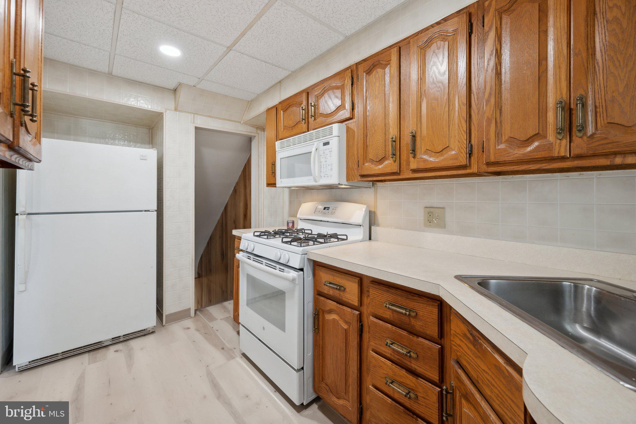 2116 Firethorn Road Middle River, MD 21220 - Photo 9 of 26 a kitchen with stainless steel appliances granite countertop a refrigerator and a sink