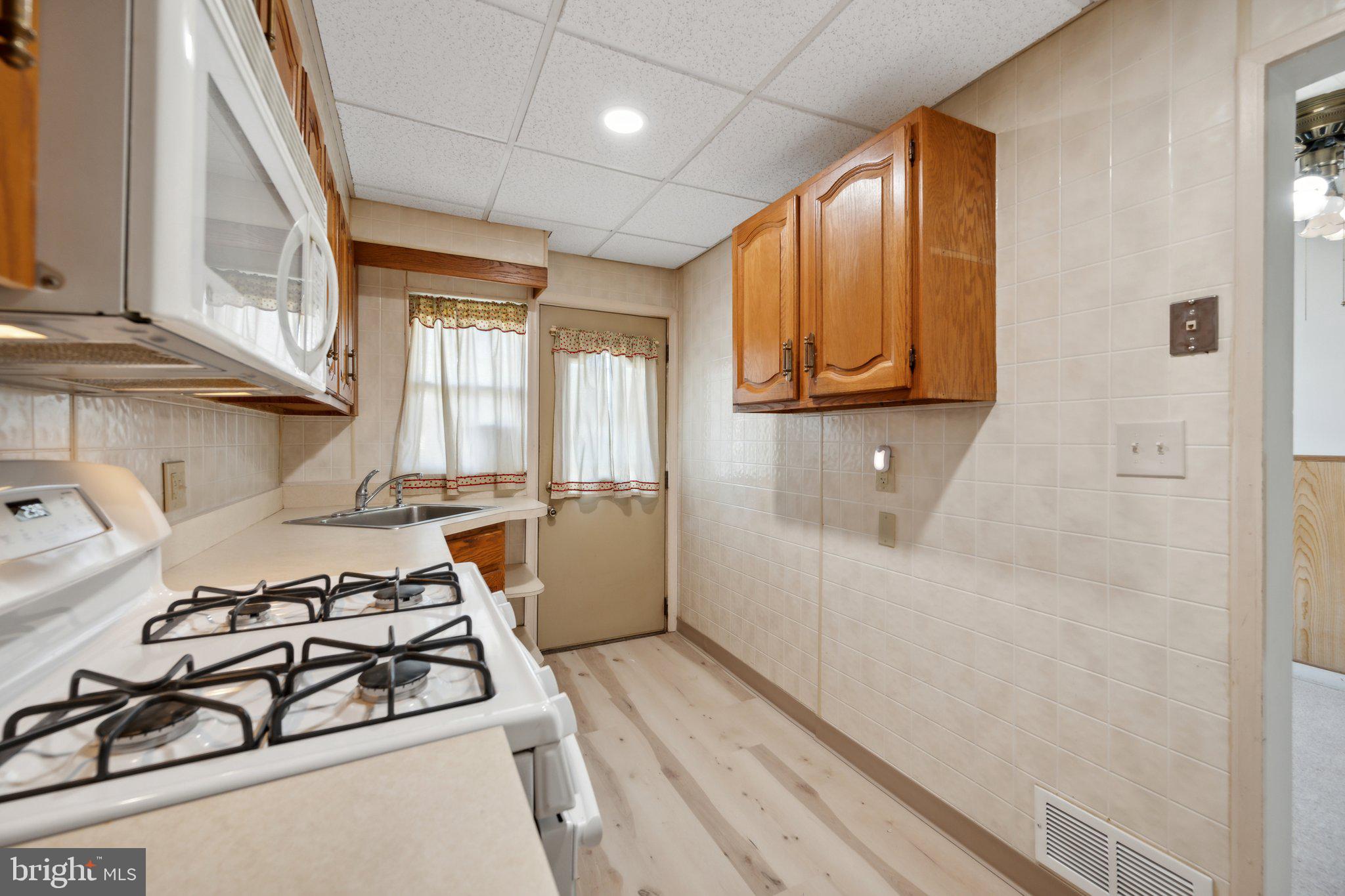 2116 Firethorn Road Middle River, MD 21220 - Photo 10 of 26 a kitchen with a stove a sink and a window