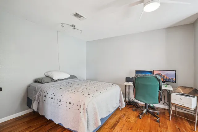 a bedroom with a bed and a chair