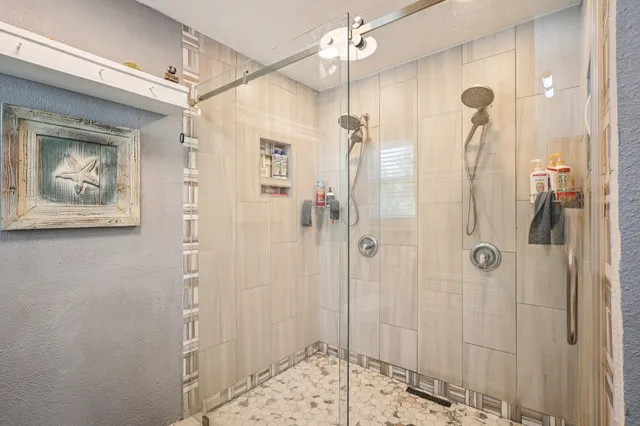 a bathroom with a shower and a sink