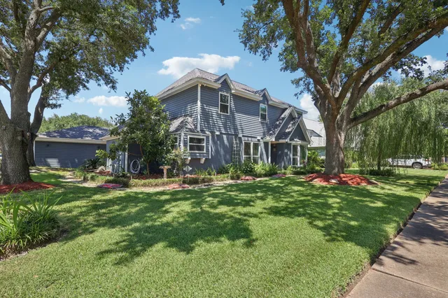 a front view of a house with a yard table and chairs