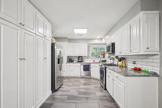 a kitchen with refrigerator and cabinets