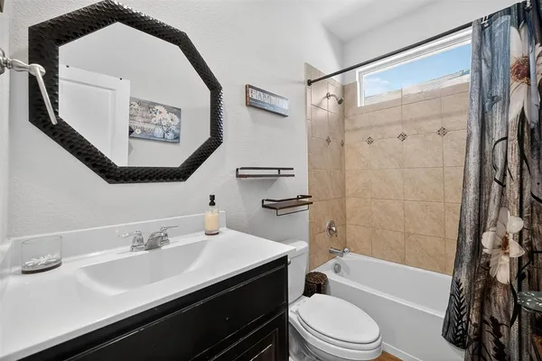 a bathroom with a sink a toilet and a bathtub