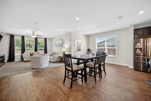 a view of a dining room with furniture window and wooden floor