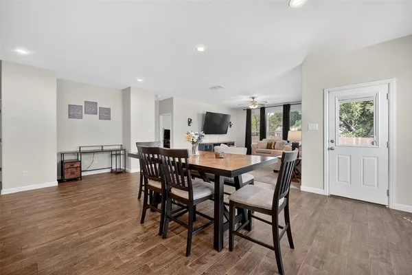 a view of a dining room with furniture and wooden floor