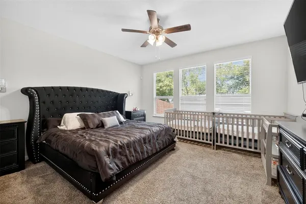 a bedroom with a bed and a large window
