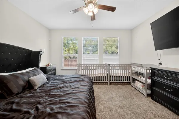 a bedroom with a bed and a flat screen tv