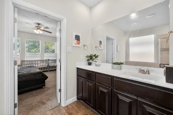 a en suite bathroom with a double vanity sink and a window