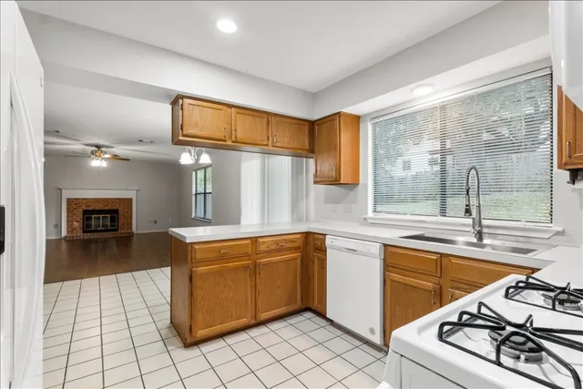 a kitchen with stainless steel appliances granite countertop a sink and a stove